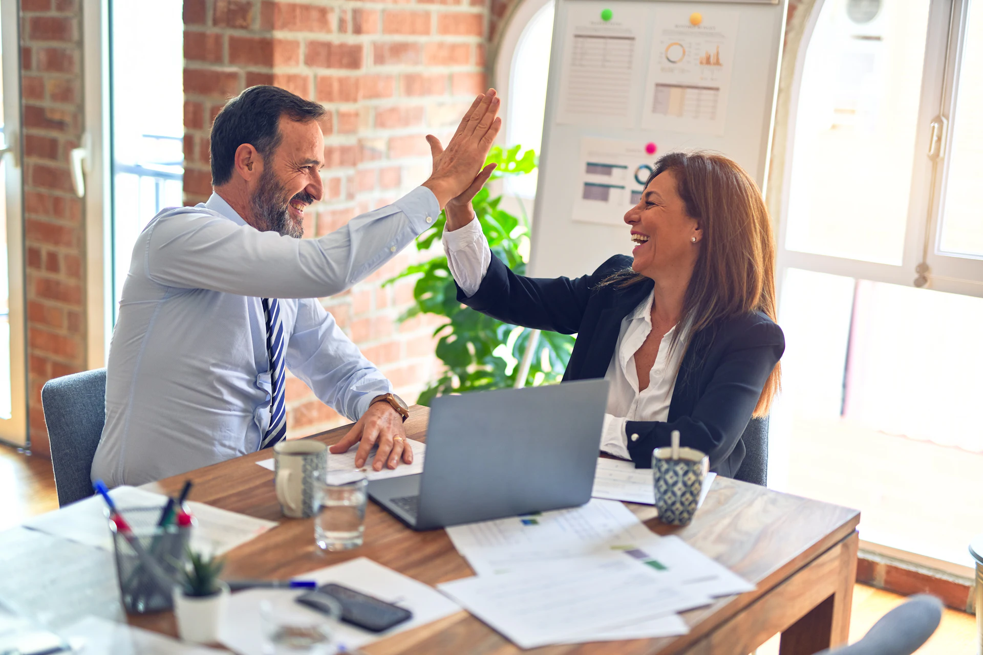 Business owners celebrating growth from digital marketing